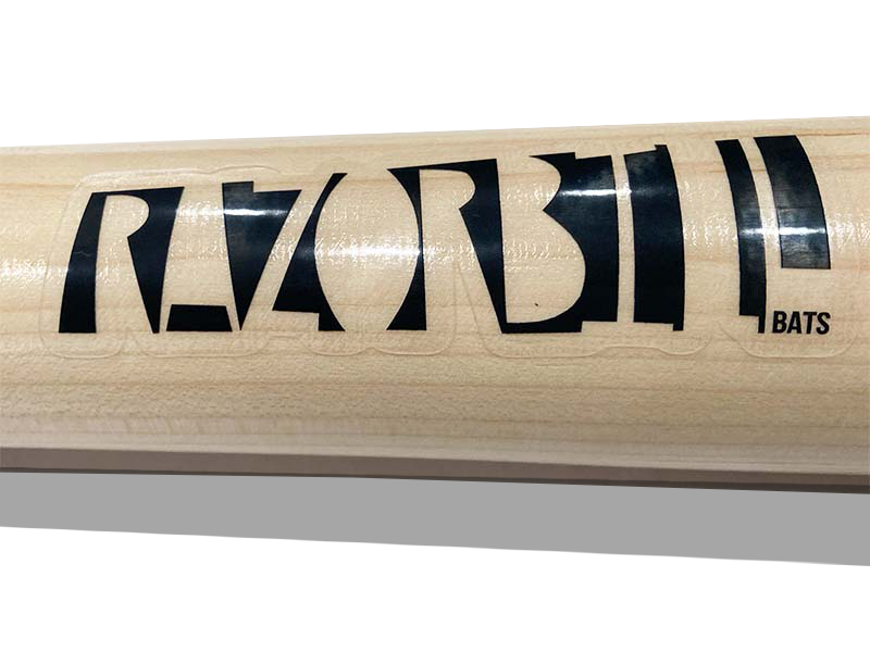Close-up of Razorbill logo on the barrel of a natural wood bat