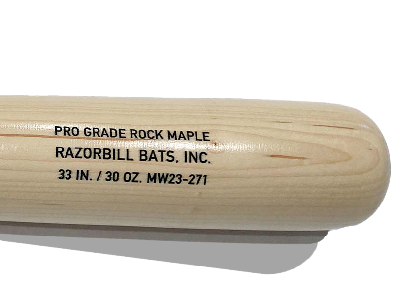 Close-up of detailed engraving on the natural wood barrel of a Razorbill bat