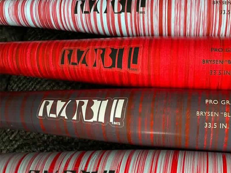 Red striped wood bats featuring the Razorbill logo on the barrel, combining bold design with game-ready performance.