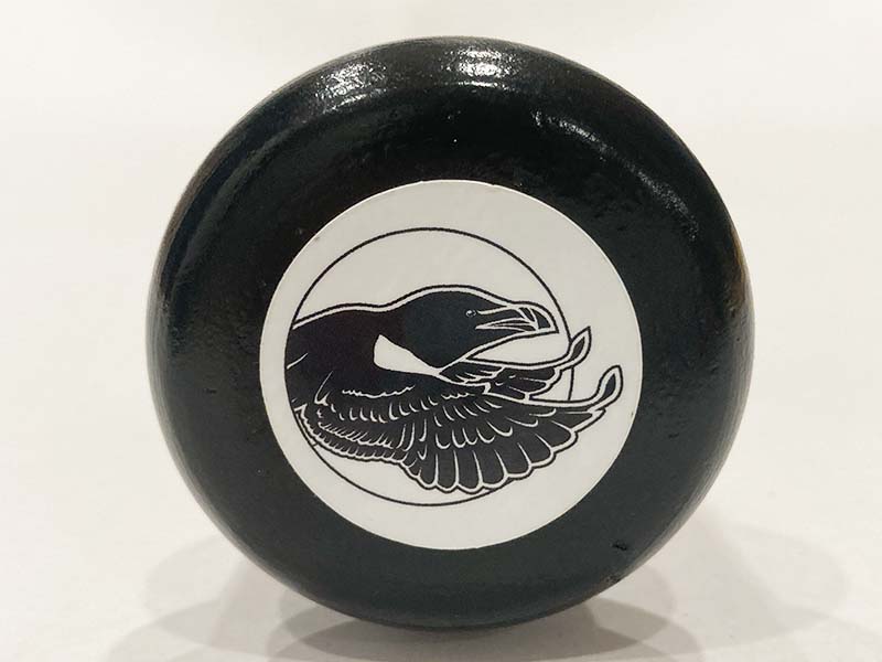 Close-up of the end of a black bat knob featuring the Razorbill bird logo, highlighting detailed branding and premium finishing touches.