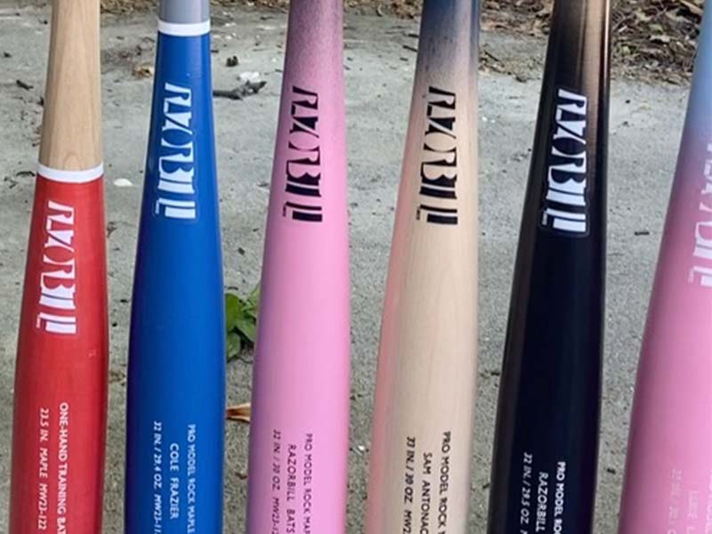 A lineup of Razorbill bats, each showcasing a sleek design with white and black logos on the barrels, highlighting the brand's signature style and craftsmanship.
