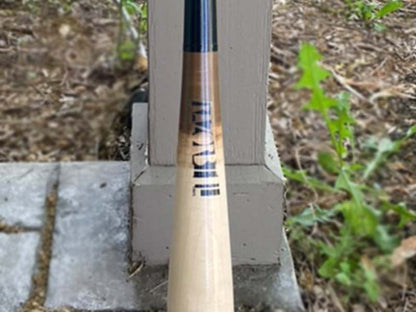 Razorbill wood bat featuring a distinctive tar fade design that transitions smoothly into a sleek black handle, with the signature Razorbill logo on the barrel.