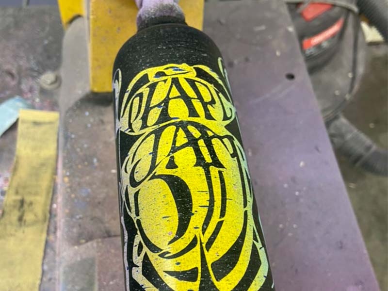 Razorbill bat with a bold yellow Pearl Jam–inspired design set against a deep black background, combining music-inspired style with premium bat craftsmanship.