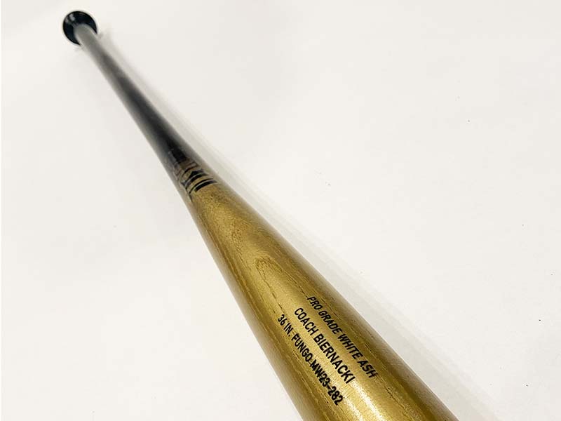Razorbill gold fungo bat with a sleek black handle, designed for coaches who want standout style and lightweight, balanced performance during practice