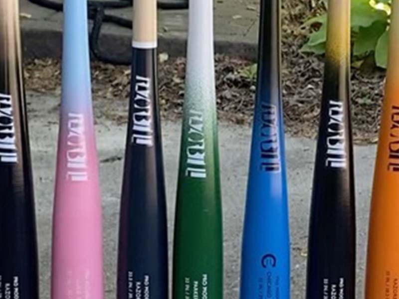 A lineup of Razorbill Standard Pro Maple Barrel Wood Bats arranged side by side, showcasing their smooth barrels, balanced profiles, and engraved barrel logos.