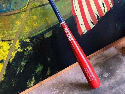 Red, white, and blue Razorbill bat displayed against an American flag background, celebrating patriotic spirit with bold colors and custom design.