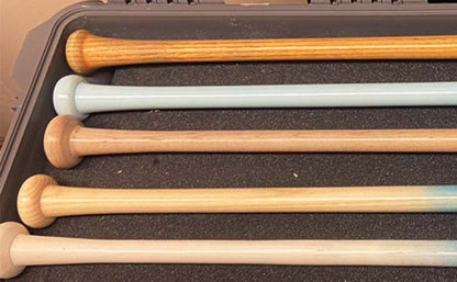 Close-up of wood grain handles on Razorbill fungo bats, showcasing the natural texture and premium craftsmanship for coaches seeking durability and style in training tools.